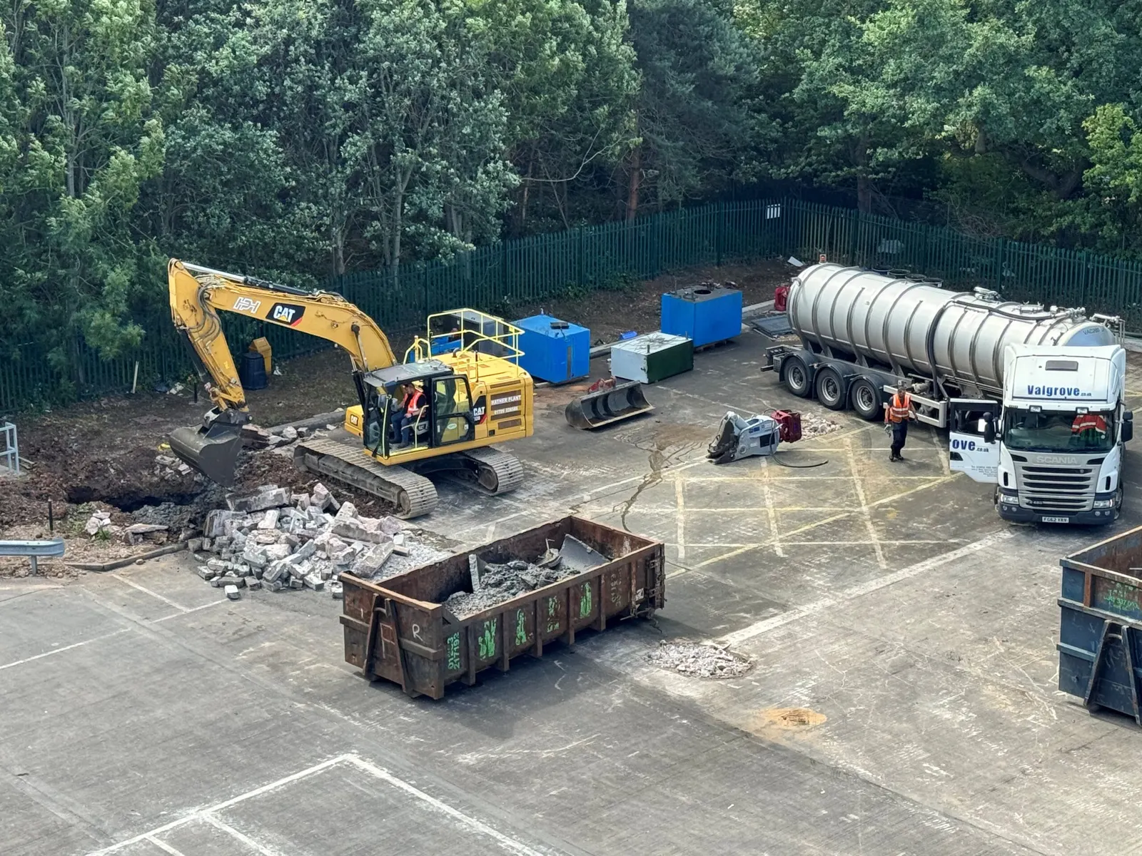 Excavator, skips and a tanker working in the yard outside the Fradley facility