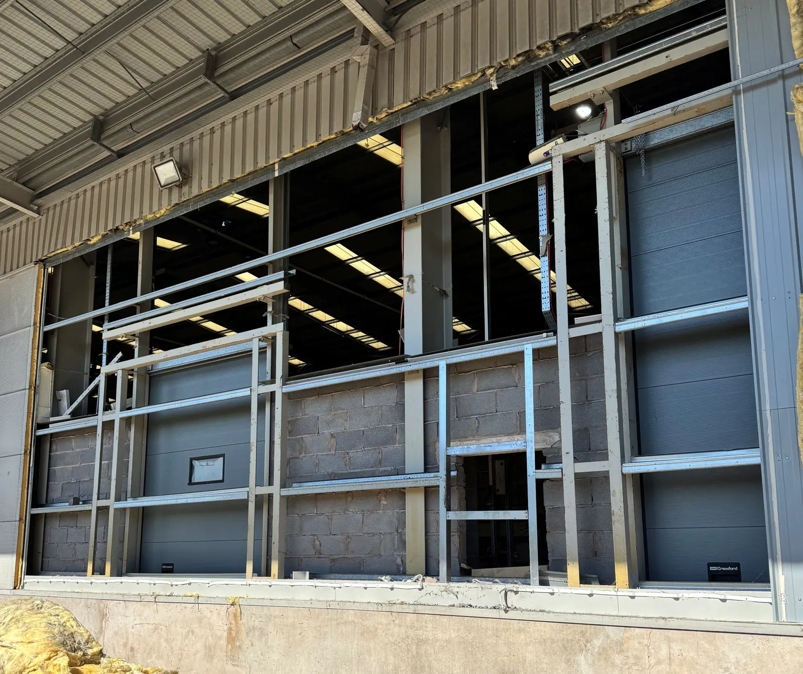 Section of external wall removed to expose steel framing and internal blockwork