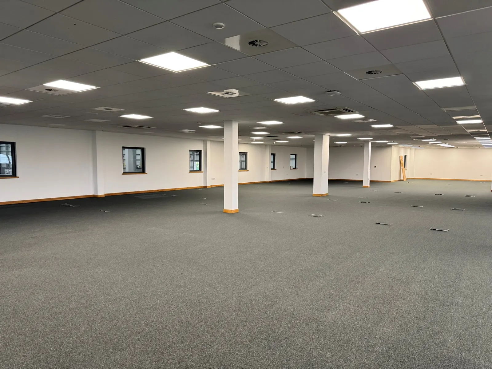 Open-plan office floor at Fradley finished with new carpet, painted walls and suspended ceiling